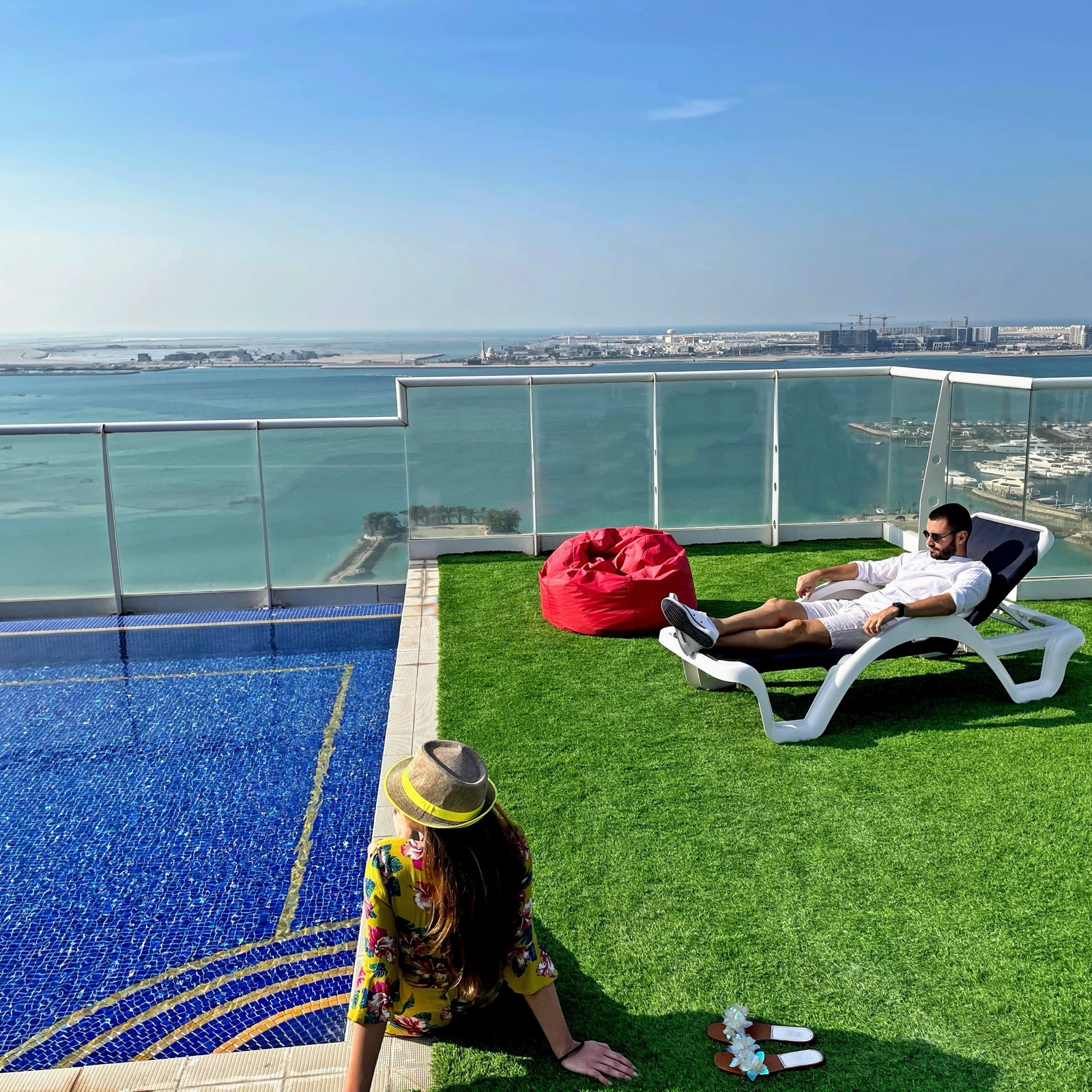Rooftop pool with sunset view at Tilal Towers